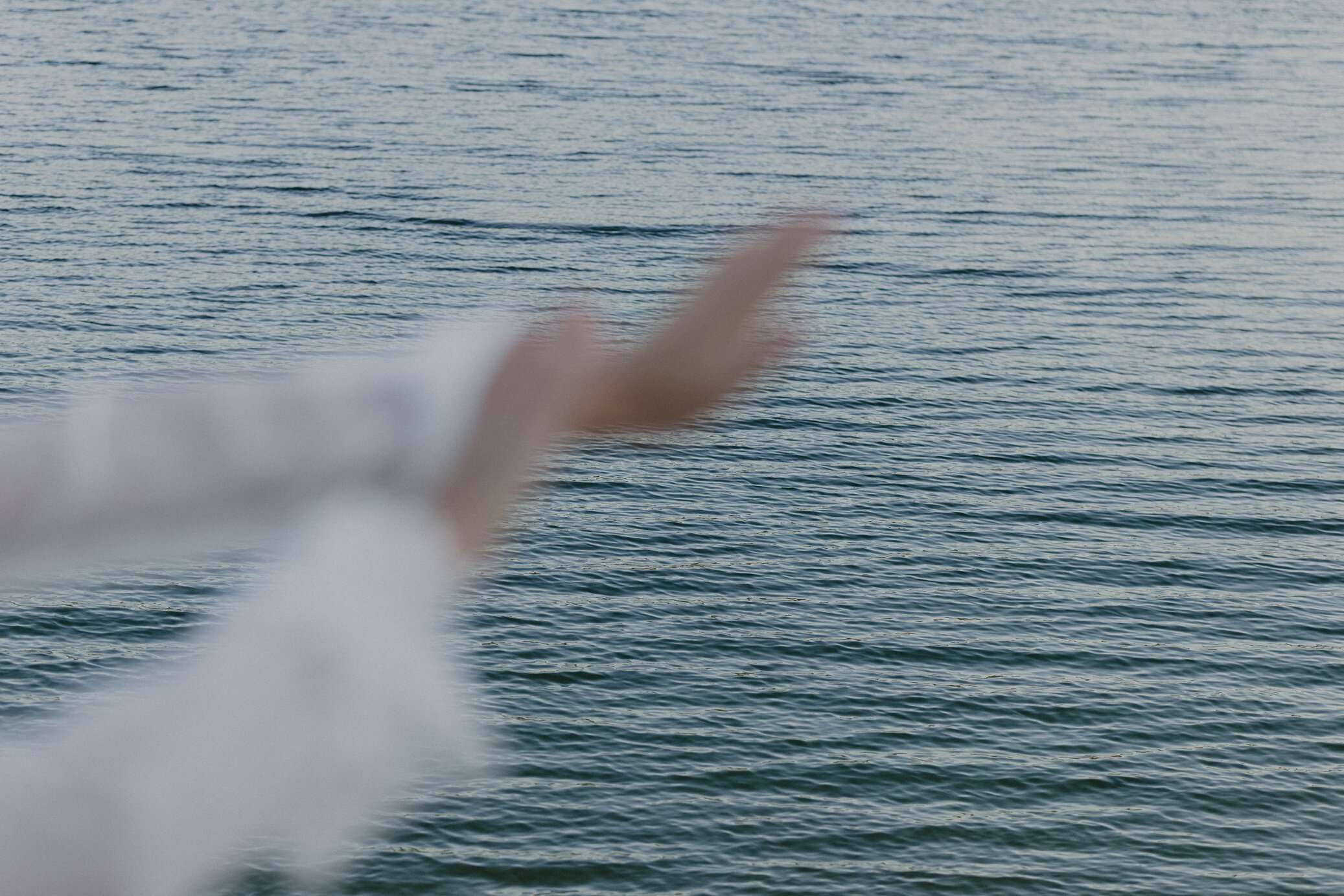 Hands Stretched Out with Calm Beach Background